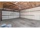 Spacious garage with large door, high ceiling, and ample room for storage and parking at 5733 Whitechapel St, Castle Rock, CO 80104