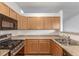 Well-lit kitchen with stainless steel appliances and wooden cabinetry at 5733 Whitechapel St, Castle Rock, CO 80104