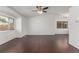 Living room features hardwood floors, ceiling fan, and ample natural light at 5733 Whitechapel St, Castle Rock, CO 80104