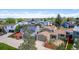 An aerial view shows this home nestled in a vibrant neighborhood with colorful houses and mature trees at 5733 Whitechapel St, Castle Rock, CO 80104