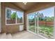 Enclosed patio with a large window and sliding glass door leading to the backyard at 5733 Whitechapel St, Castle Rock, CO 80104