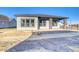 Modern home exterior with covered patio and stone accents at 8871 S Quemoy St, Aurora, CO 80016