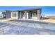 Modern home exterior with covered patio and stone accents at 8871 S Quemoy St, Aurora, CO 80016