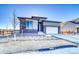 Modern home with stone and siding exterior and two-car garage at 8871 S Quemoy St, Aurora, CO 80016