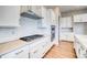 Modern kitchen with white cabinets and large island at 8871 S Quemoy St, Aurora, CO 80016