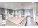 Modern kitchen with island, white cabinets, and stainless steel appliances at 8871 S Quemoy St, Aurora, CO 80016