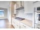 White kitchen with gas cooktop and marble backsplash at 8871 S Quemoy St, Aurora, CO 80016