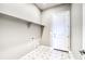 Laundry room with tile floor and built-in shelving at 8871 S Quemoy St, Aurora, CO 80016