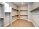 Spacious walk-in closet with ample shelving and hanging rods at 8871 S Quemoy St, Aurora, CO 80016