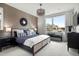 Well-decorated primary bedroom with a large window, comfortable bed, and stylish furnishings at 888 S Valentia St # 101, Denver, CO 80247