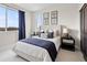 Bright primary bedroom with a large window, plush bedding, and a tranquil decor style at 888 S Valentia St # 101, Denver, CO 80247