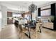 Bright open-concept dining room with a modern chandelier, wood floors, and stainless steel appliances at 888 S Valentia St # 101, Denver, CO 80247