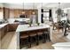 The kitchen features stainless steel appliances, a large island, and light hardwood floors and cabinetry at 888 S Valentia St # 101, Denver, CO 80247