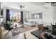 Bright living room features stylish decor, a comfortable couch, and a glass sliding door to a balcony at 888 S Valentia St # 101, Denver, CO 80247