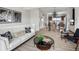 Well-lit living room featuring modern decor, a comfortable couch, and an open view of the kitchen at 888 S Valentia St # 101, Denver, CO 80247
