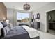 Beautiful main bedroom with a large window and a modern light fixture at 888 S Valentia St # 101, Denver, CO 80247