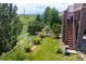 Backyard with lush green grass and stairs leading up to the deck at 3216 Yale Dr, Broomfield, CO 80023