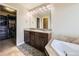 Primary bathroom featuring dual sinks, granite countertops, and a soaking tub at 3216 Yale Dr, Broomfield, CO 80023