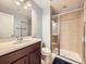 Bathroom featuring a sink, mirror, and shower with glass door at 3216 Yale Dr, Broomfield, CO 80023