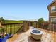 Wooden deck with fire pit and views of open fields at 3216 Yale Dr, Broomfield, CO 80023