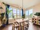 Bright dining room featuring a rustic wood table, large windows with natural light, and access to outdoor patio at 3216 Yale Dr, Broomfield, CO 80023