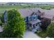 Aerial view of blue two-story home showcasing the roof, landscaping, and community views at 3216 Yale Dr, Broomfield, CO 80023