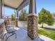 Covered front porch with stone pillars and seating at 3216 Yale Dr, Broomfield, CO 80023