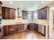 Well-equipped kitchen with stainless steel appliances, stylish backsplash, dark wood cabinets, and hardwood floors at 3216 Yale Dr, Broomfield, CO 80023
