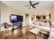 Comfortable living room with hardwood floors, ceiling fan, and an open layout leading to the kitchen at 3216 Yale Dr, Broomfield, CO 80023