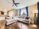 Inviting living room with hardwood floors, a large window, stylish decor, and a comfortable sectional sofa at 3216 Yale Dr, Broomfield, CO 80023