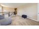 Open loft living room with neutral tones, natural light, and plush carpeting at 3216 Yale Dr, Broomfield, CO 80023