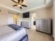 Bright main bedroom with neutral walls and modern furnishings, including dressers and a TV at 3216 Yale Dr, Broomfield, CO 80023