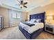 Tranquil main bedroom with a large window, tray ceiling, and elegant furnishings at 3216 Yale Dr, Broomfield, CO 80023