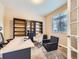 Functional home office with a desk, shelving, comfortable seating, and natural light from the window at 3216 Yale Dr, Broomfield, CO 80023