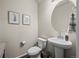 Cozy powder room featuring a pedestal sink, modern fixtures, and tasteful wall decor at 12205 Race St, Northglenn, CO 80241