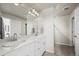 Bright bathroom with double sinks, white cabinets, and modern lighting fixtures at 12205 Race St, Northglenn, CO 80241