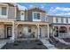 Charming townhome showcasing a stone facade, covered porch, and manicured landscaping, exuding curb appeal and inviting charm at 12205 Race St, Northglenn, CO 80241