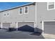 Exterior shot of attached garages featuring modern gray doors with the house number above each one at 12205 Race St, Northglenn, CO 80241