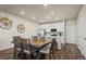 Modern kitchen with white cabinetry and stainless steel appliances, adjoining a dining area perfect for Gathering meals at 12205 Race St, Northglenn, CO 80241