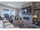 Modern living room with fireplace, large TV, and comfortable seating at 481 Woodroot Cir, Castle Rock, CO 80104