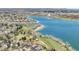 Aerial view of lakeside homes featuring lush landscaping and direct access to the lake at 8312 S Peninsula Dr, Littleton, CO 80120