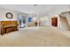 Finished basement with neutral carpet, piano, walk-out door and furniture at 8312 S Peninsula Dr, Littleton, CO 80120