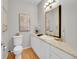 Stylishly designed half bathroom featuring a white vanity and golden framed mirror at 8312 S Peninsula Dr, Littleton, CO 80120