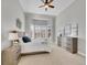 Bright bedroom featuring a ceiling fan, soft carpet, and multiple windows with plantation shutters at 8312 S Peninsula Dr, Littleton, CO 80120