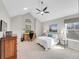 Bright bedroom with vaulted ceiling, ceiling fan, large windows, desk and comfortable furniture at 8312 S Peninsula Dr, Littleton, CO 80120