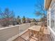 Relaxing outdoor deck with a dining table, chairs, and a scenic neighborhood view at 8312 S Peninsula Dr, Littleton, CO 80120