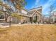 Charming two-story home featuring a stone facade, two-car garage, and professionally landscaped yard at 8312 S Peninsula Dr, Littleton, CO 80120