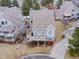 Aerial view of the house and landscaped surroundings highlighting the large deck on a sunny day at 8312 S Peninsula Dr, Littleton, CO 80120
