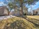 Attractive two-story home boasts a stone and siding exterior, complemented by a well-kept lawn and mature trees at 8312 S Peninsula Dr, Littleton, CO 80120