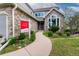 Charming stone front exterior with landscaped walkway and Steller Group real estate sign at 8312 S Peninsula Dr, Littleton, CO 80120